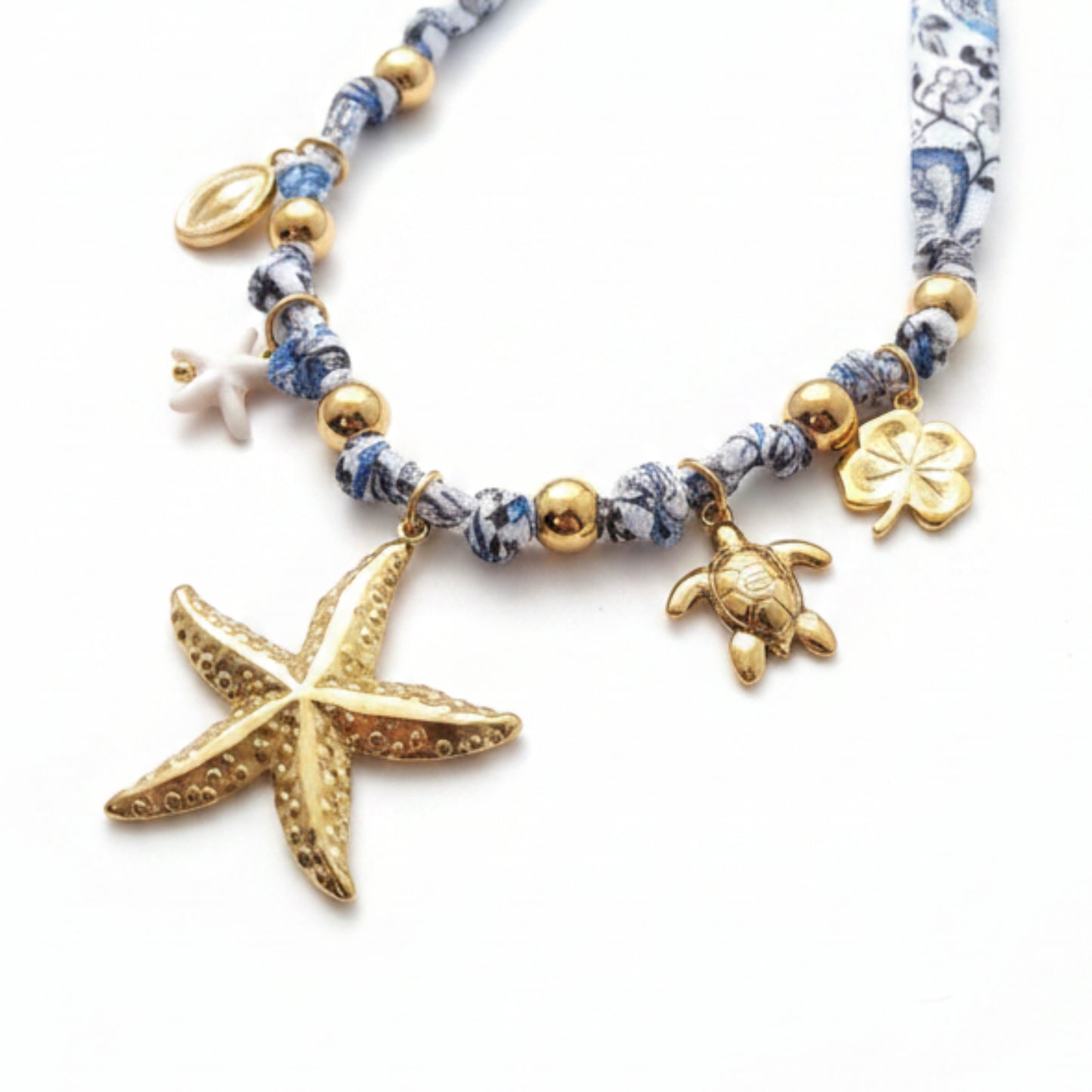 COLLANA STELLA MARINA CON TESSUTO FANTASIA BLU E BIANCO IN ACCIAIO GOLD